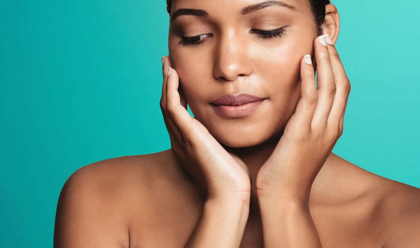 Close-up of a woman with eyes closed framing her face with both hands for Morpheus8 skin remodelling in London